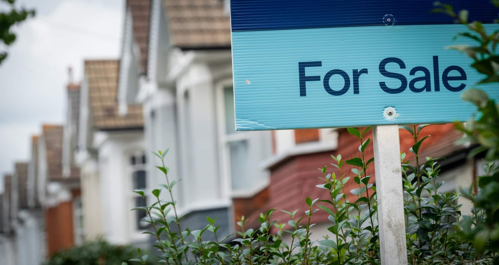 For Sale Sign Terraced Homes For Sale sign in front of terraced houses.
