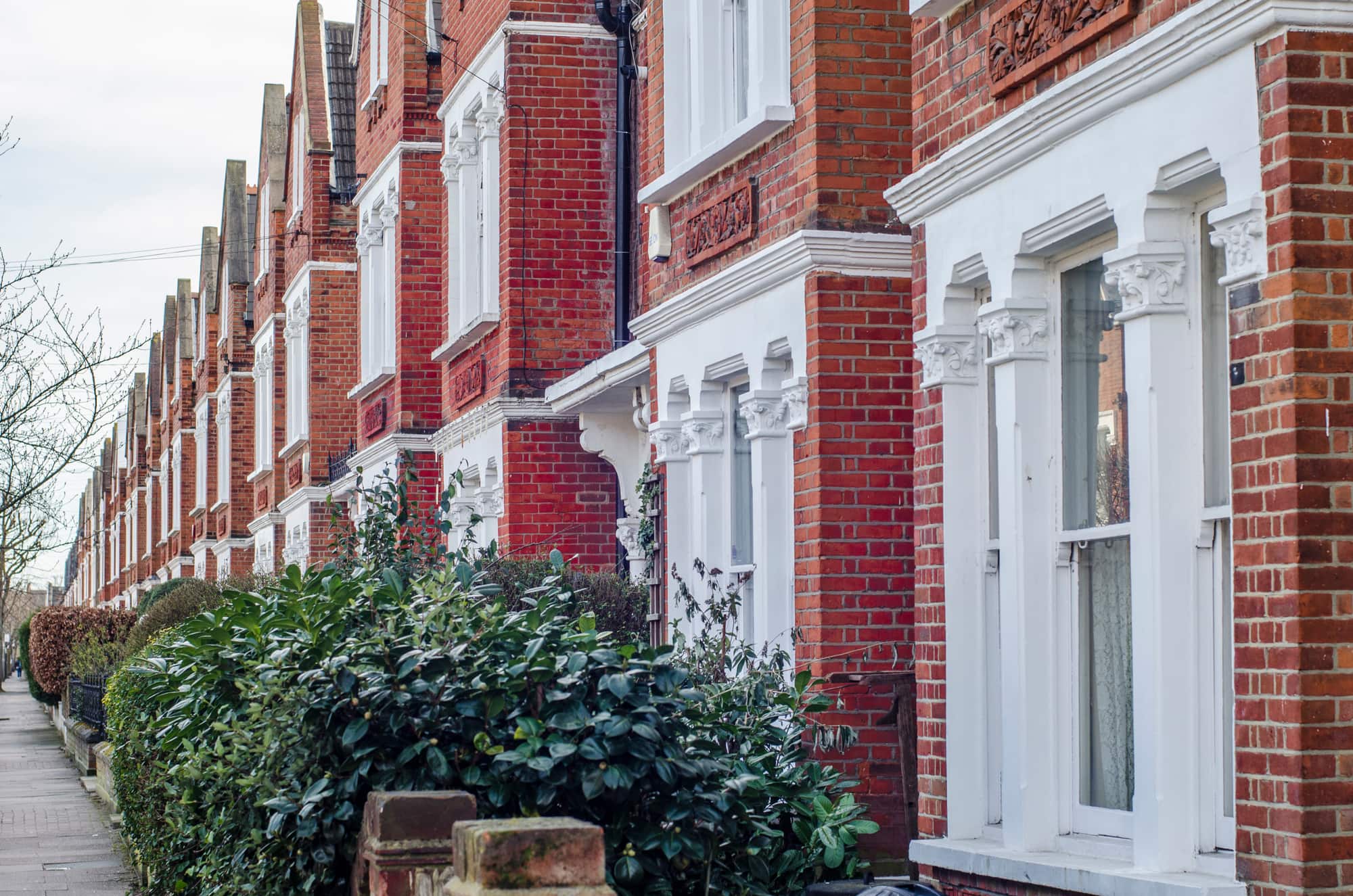 Period Terraces Leafy Front Gardens Red-brick terraced houses with ornate white bay windows and leafy front gardens.