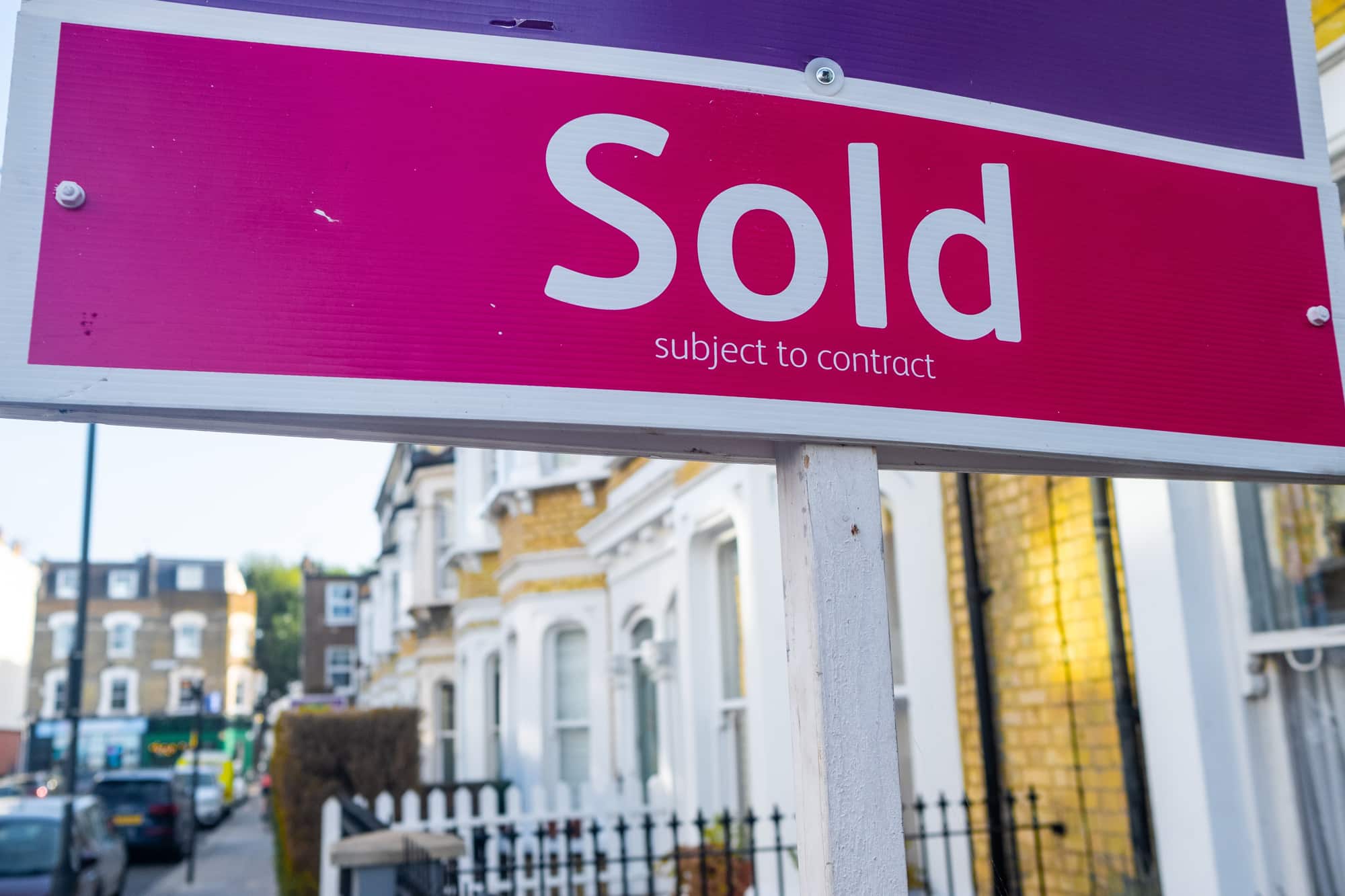 Sold subject to contract sign outside a row of houses.