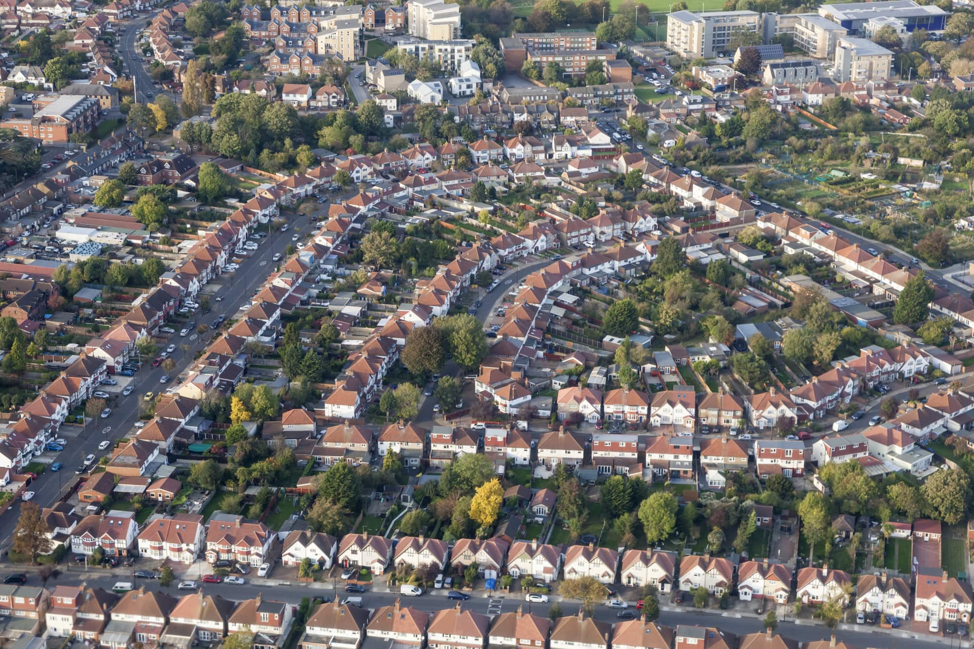Aerial view of suburban streets lined with houses and gardens.